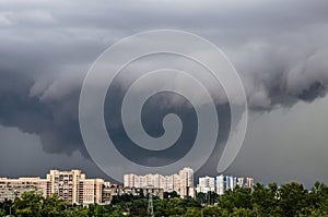 Tornado, thunderstorm, funnel clouds over the city.