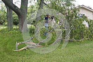 Tornado Wind Storm Damage Man Chainsaw Downed Tree photo