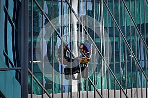 TORONTO, CANADA - 06 16 2016: Industrial climber cleaning the glassy wall of Canadian Broadcasting Centre building in downtown