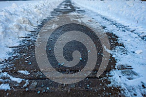 Toronto, CANADA - January 27th, 2019: Canadian blue salt on roads for better melting of ice with liquid magnesium chloride