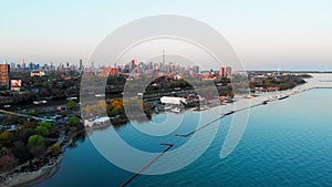 Toronto, Canada - May 6, 2023: Drone flying over river along highway filled with cars. Busy metropolis with skyscrapers