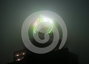 Toronto, Canada - 10 30 2021: Misty dark night sky with glowing TD bank logo on top of TD Canada Trust Tower in downtown
