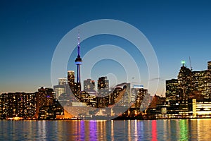 The Toronto, Canada skyline at night with harbour reflections