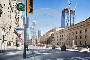 Toronto, Ontario, Canada - April 2, 2020: Downtown Toronto during Coronavirus pandemic. Rare passers-by on the street of Toronto