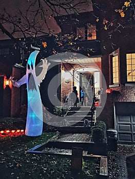 Toronto, Ontario, Canada - October 31, 2019: Children friends trick or treating on Halloween holiday. Kids boy and girl in party