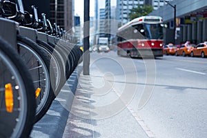 Toronto streetcar and taxis on busy street bike rental station p