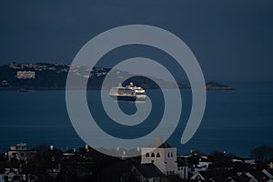 Torquay Devon cruise ship lit up in bay
