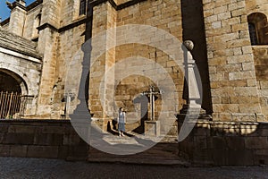 Torre de Moncorvo Castle with crosses status and a young lady standing next to in Portugal photo