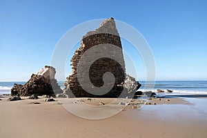 Torre del Loro Mazagon remains at Playa de Rompeculos beach in Mazagon, Spain photo