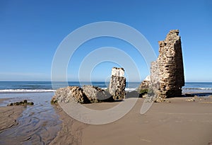 Torre del Loro Mazagon ruin at Playa de Rompeculos beach in Mazagon, Spain photo