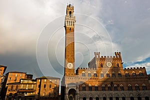 Torre del Mangia, clock tower of a city hall on Piazza del Campo main square in Siena, Tuscany