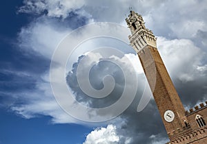 Torre del Mangia among spring clouds, Siena, Tuscany, Italy