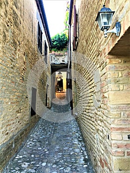 Torre di Palme town in Marche region, Italy. Ancient street, nature and light