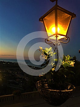 Torre di Palme town in Marche region, Italy. Sunset, sea, light and street lamp photo