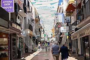 TORREMOLINOS, SPAIN, Andalusia, Costa del Sol - May 21, 2019. Shopper and tourists are walking along most popular street in old