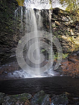 Torrent of water cascading over Whitfield Gill Force waterfall in woods, Askrigg, Yorkshire Dales