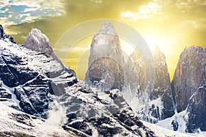 Torres del Paine peaks coming from clouds at sunset times