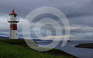 Torshavn lighthouse and ship on Faroe Islands photo