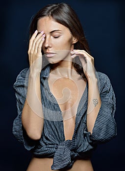 Torso portrait of the beautiful woman in a shirt in studio