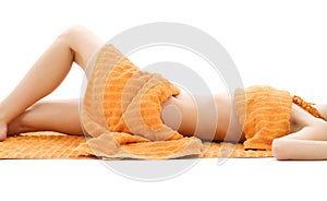 Torso of relaxed lady with orange towels