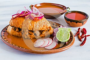 Tortas ahogadas, traditional Mexican Food from Jalisco Guadalajara Mexico, spicy sandwich in a red sauce photo