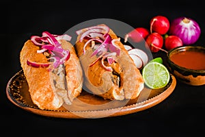 Tortas ahogadas, traditional Mexican Food from Jalisco Guadalajara Mexico, spicy sandwich in a red sauce