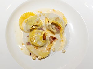 Tortelli on parmesan fondue and crunchy pig jowl