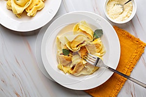 Tortelli or tortelloni di zucca, italian pasta pumpkin ravioli. photo