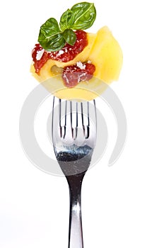 Tortellini on a fork isolated on white