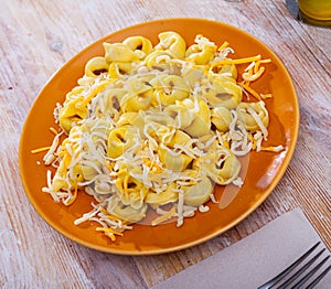 Tortellini with minced meat served with grated cheese