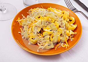 Tortellini with minced meat served with grated cheese