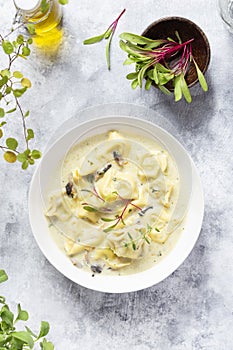 Tortellini pasta soup with spinach, carrot and chicken