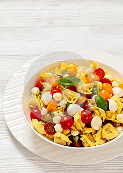 tortellini salad with tomatoes, mozzarella in bowl