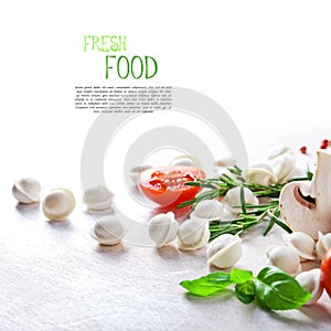 Tortellini and vegetables on white wooden background photo