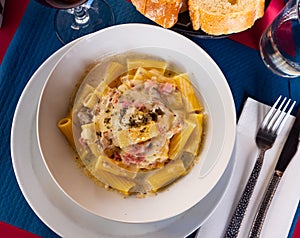 Tortiglioni in carbonara cheese sauce with cured meat guanciale