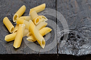 Tortiglioni noodle on dark rustic wood