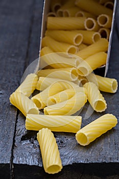 Tortiglioni noodle on dark rustic wood