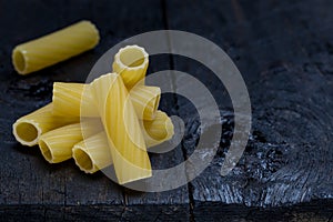 Tortiglioni noodle on dark rustic wood