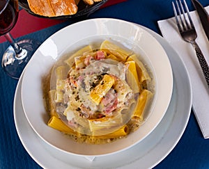 Tortiglioni pasta carbonara with cheese sauce and cured pork