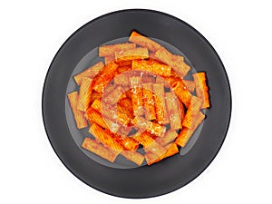 Tortiglioni pasta with tomato sauce isolated on white background