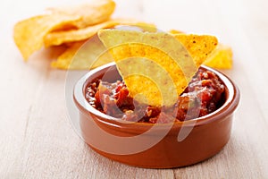 Tortilla chip with hot salsa dip photo