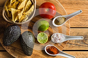 Tortilla chips and ingredients for guacamole dip