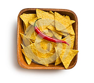 Tortilla chips with red chili pepper in wooden background