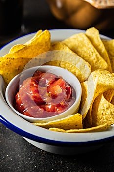 Tortilla chips and red tomato salsa dip. Mexican nacho chips