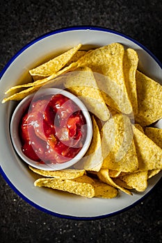 Tortilla chips and red tomato salsa dip. Mexican nacho chips