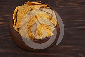 Tortilla chips on wooden background.