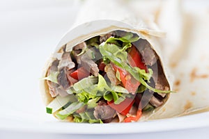 Tortilla with a delicious grilled meat and fresh mixed salad