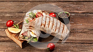 Tortilla wrap with asparagus, cherry tomatoes, avocado, chicken fillet and fresh salad. healthy food. Top view. Long banner format