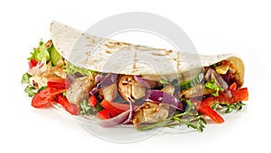 Tortilla wrap with fried chicken meat and vegetables