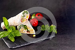 Tortilla wrapped with fried chicken meat, vegetables and corn